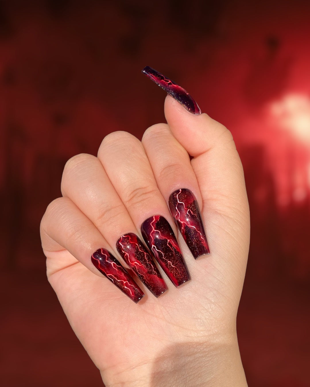 Galaxy Glows: Black & Red Nail Magic